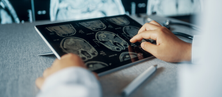 radiologist looking at CT examination image on a computer monitor