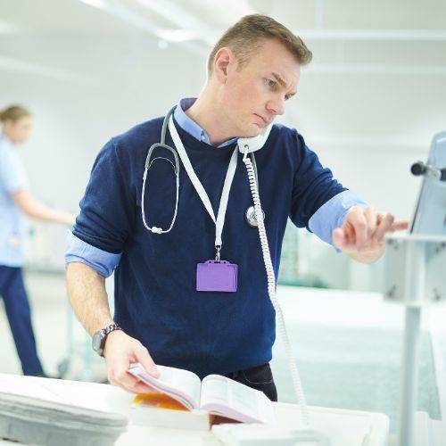 doctor checking equipment on ward