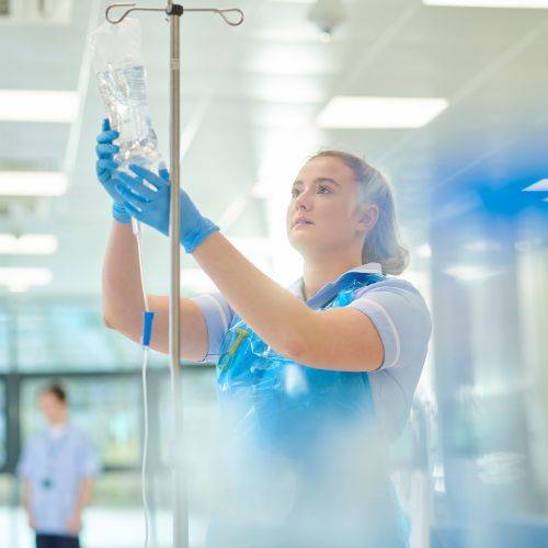 nurse hanging drip