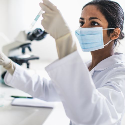 female scientist checking test tube
