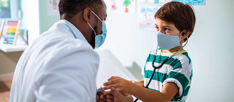 Male Paediatrician treating young boy