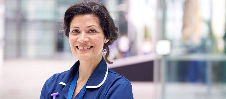 Nurse and doctor talking whilst walking upstairs